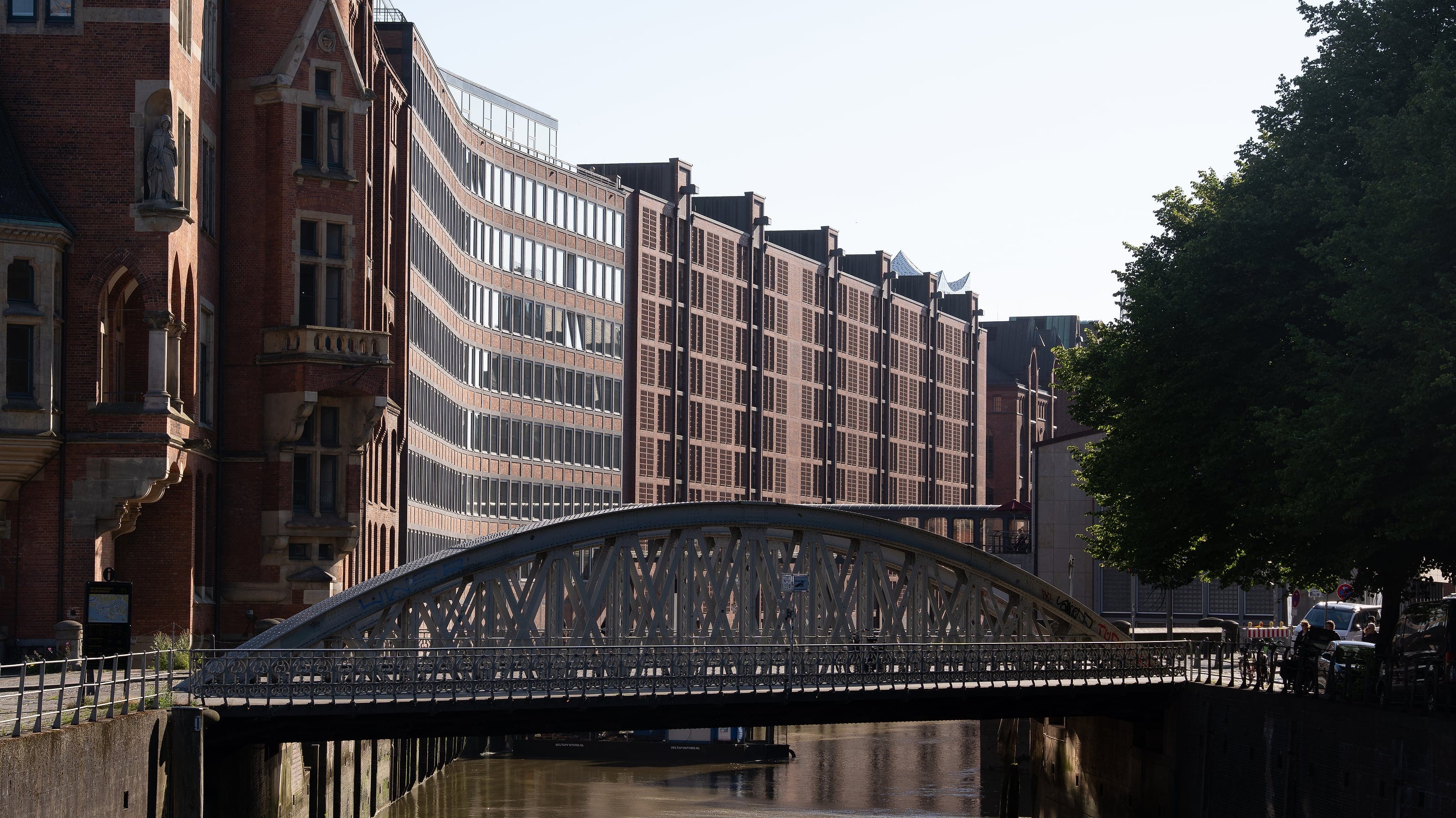 An iron bridge over a warehouse-district canal