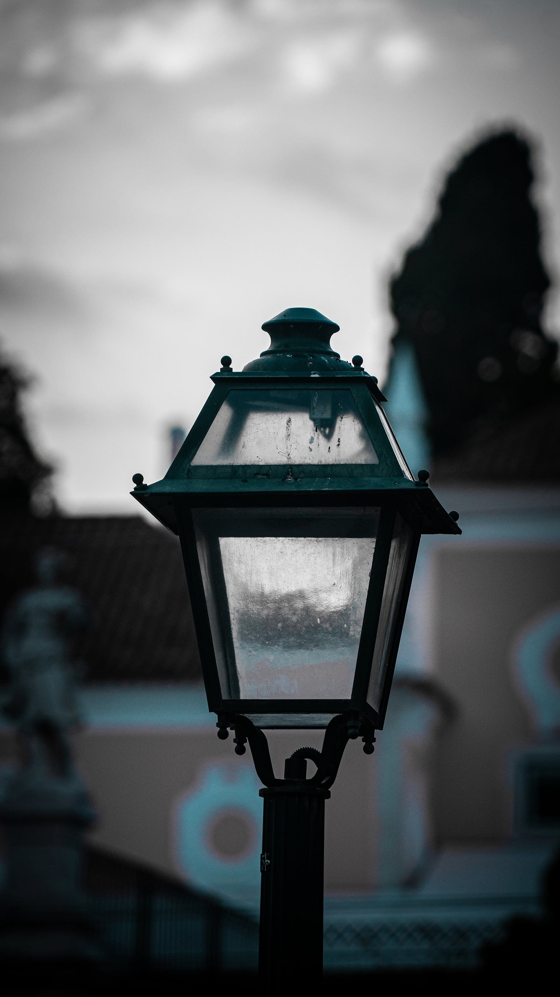 An ornate street lamp against a soft sky