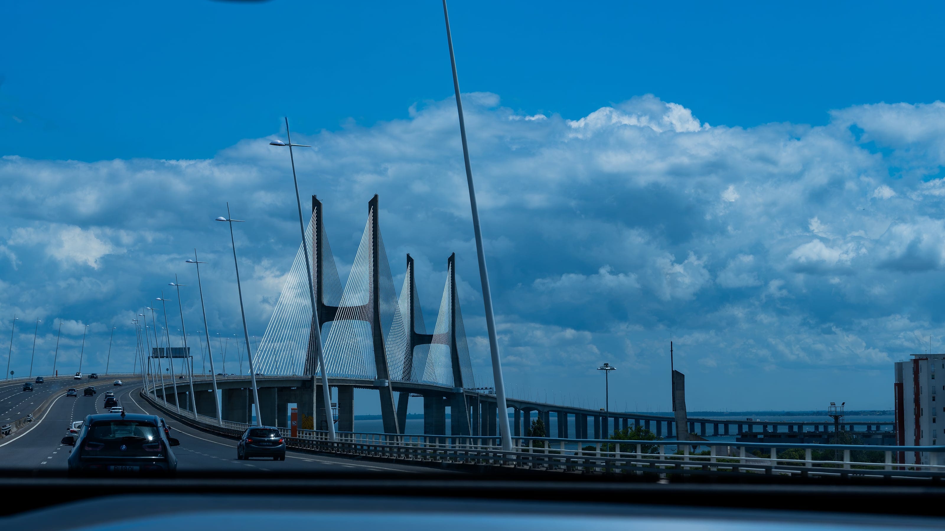 A cable-stayed bridge under a bright sky
