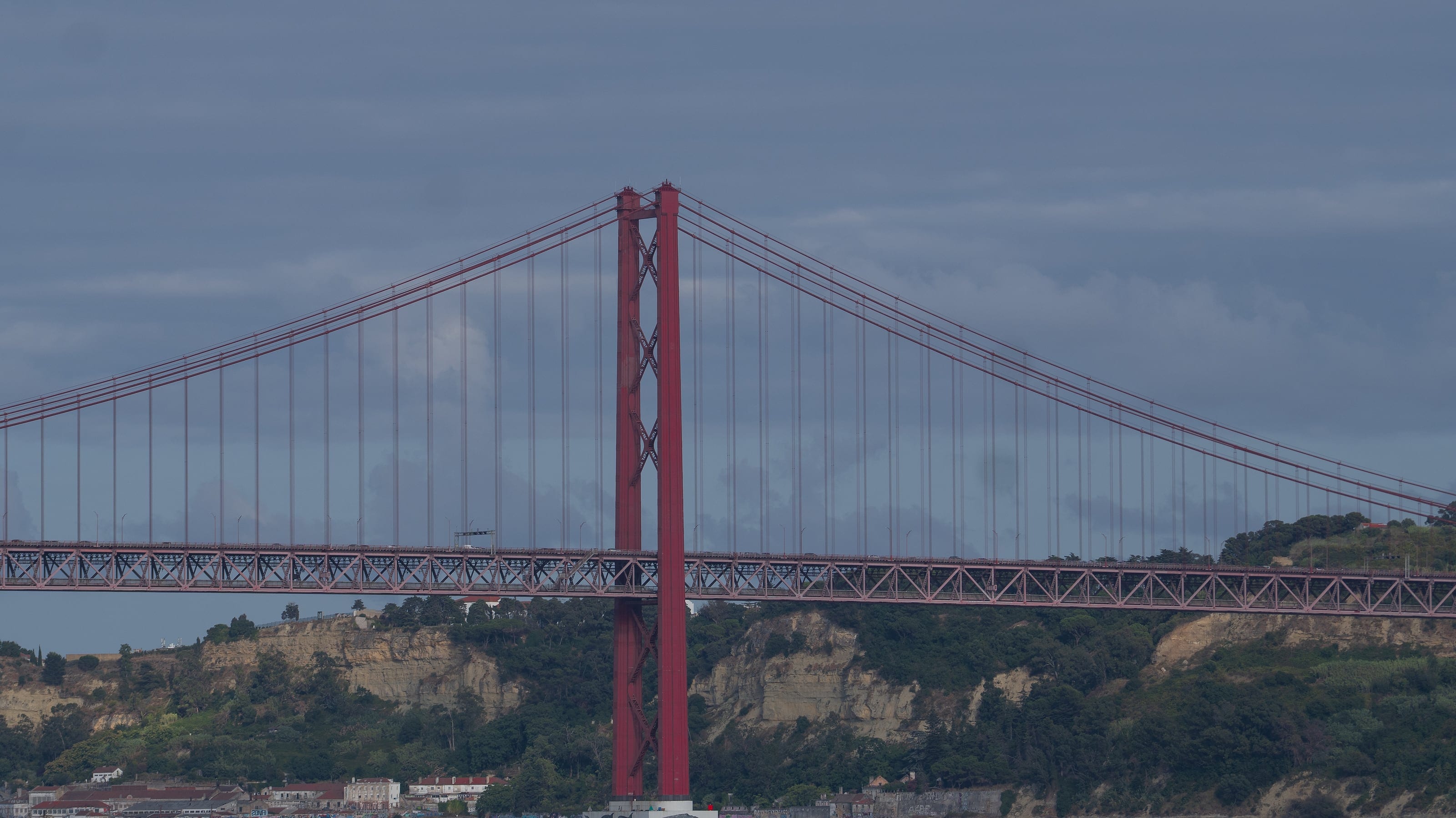A red suspension bridge above the water