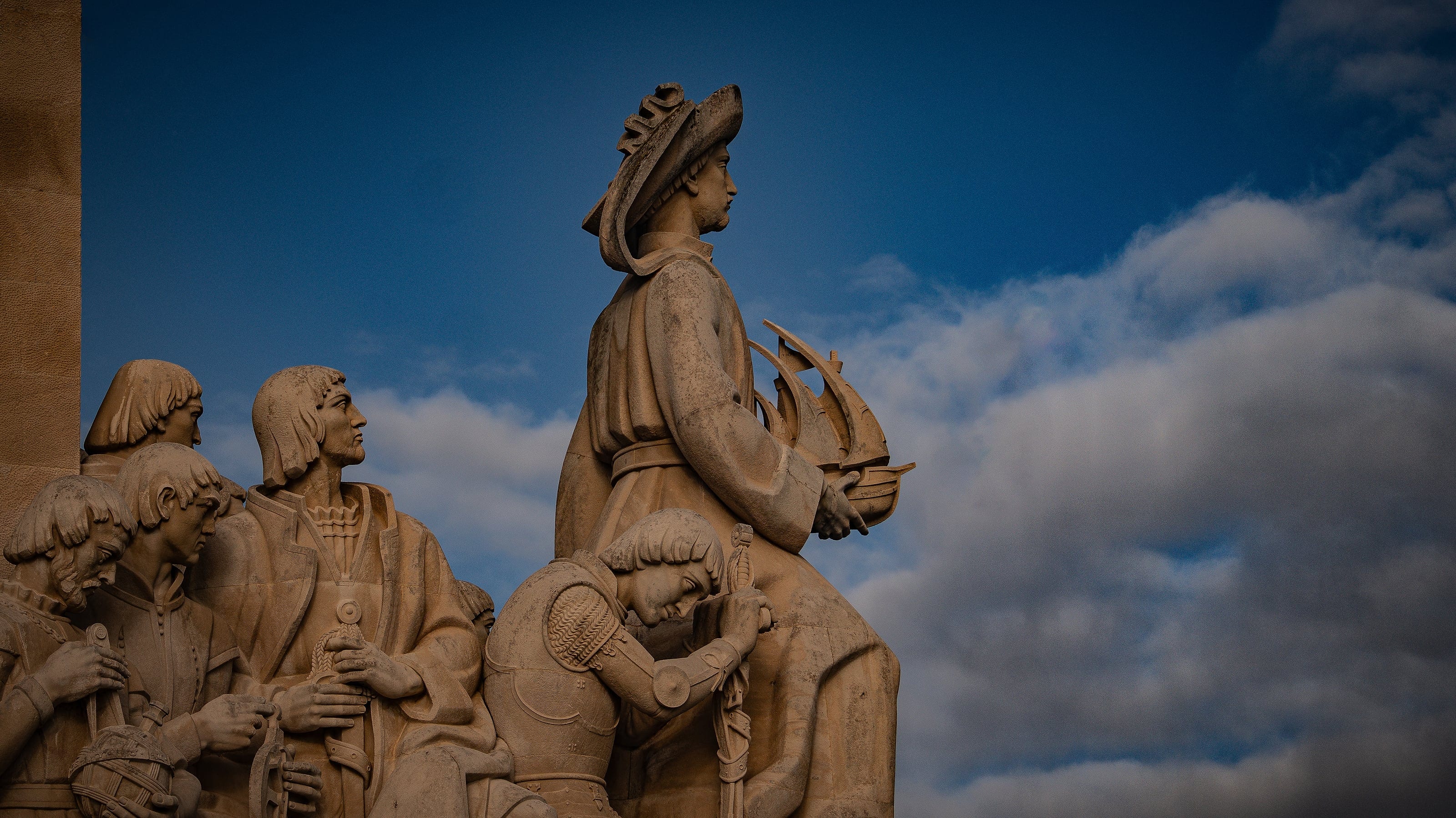 Monumental figures silhouetted against the sky
