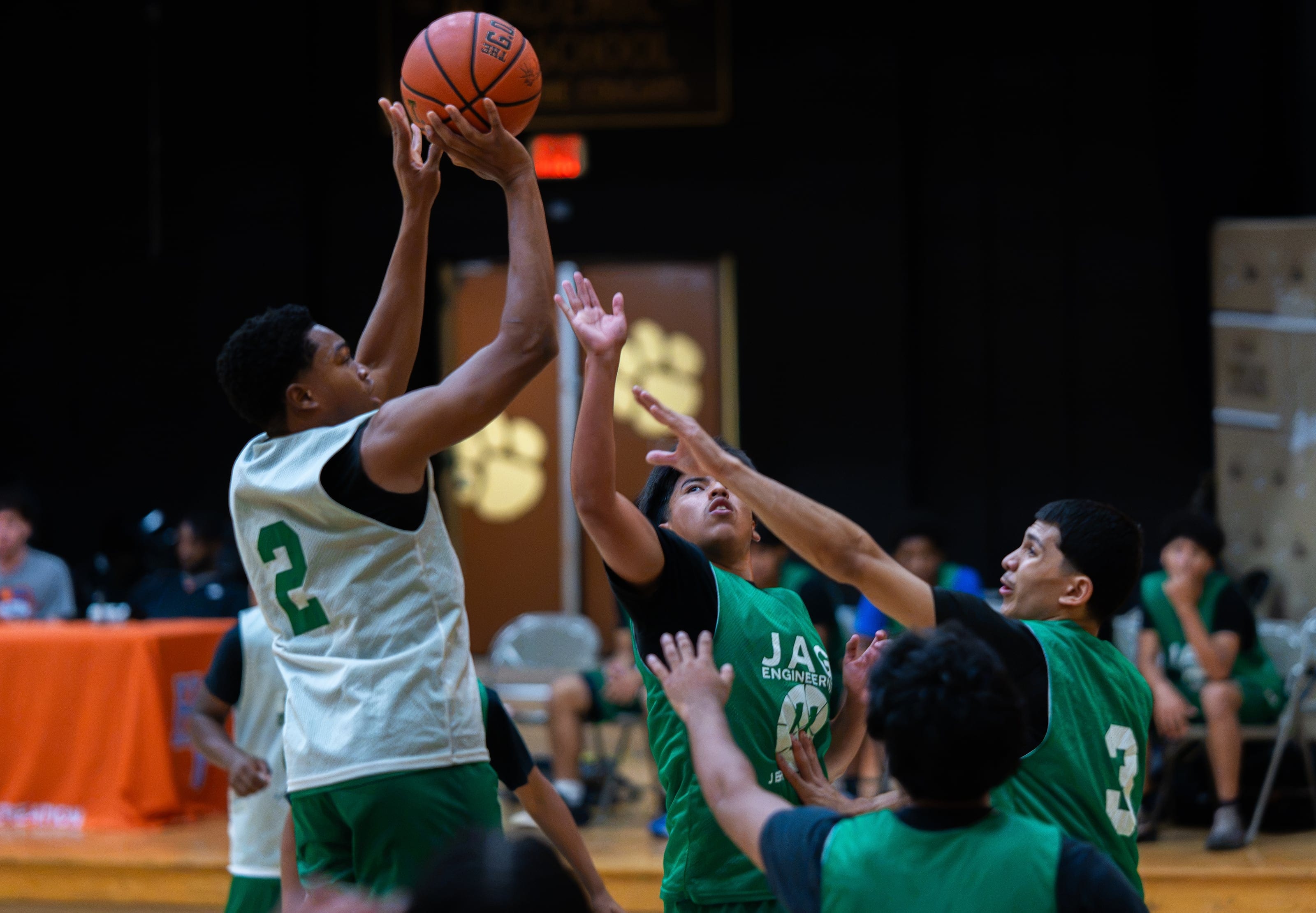 A jumper released over three outstretched hands
