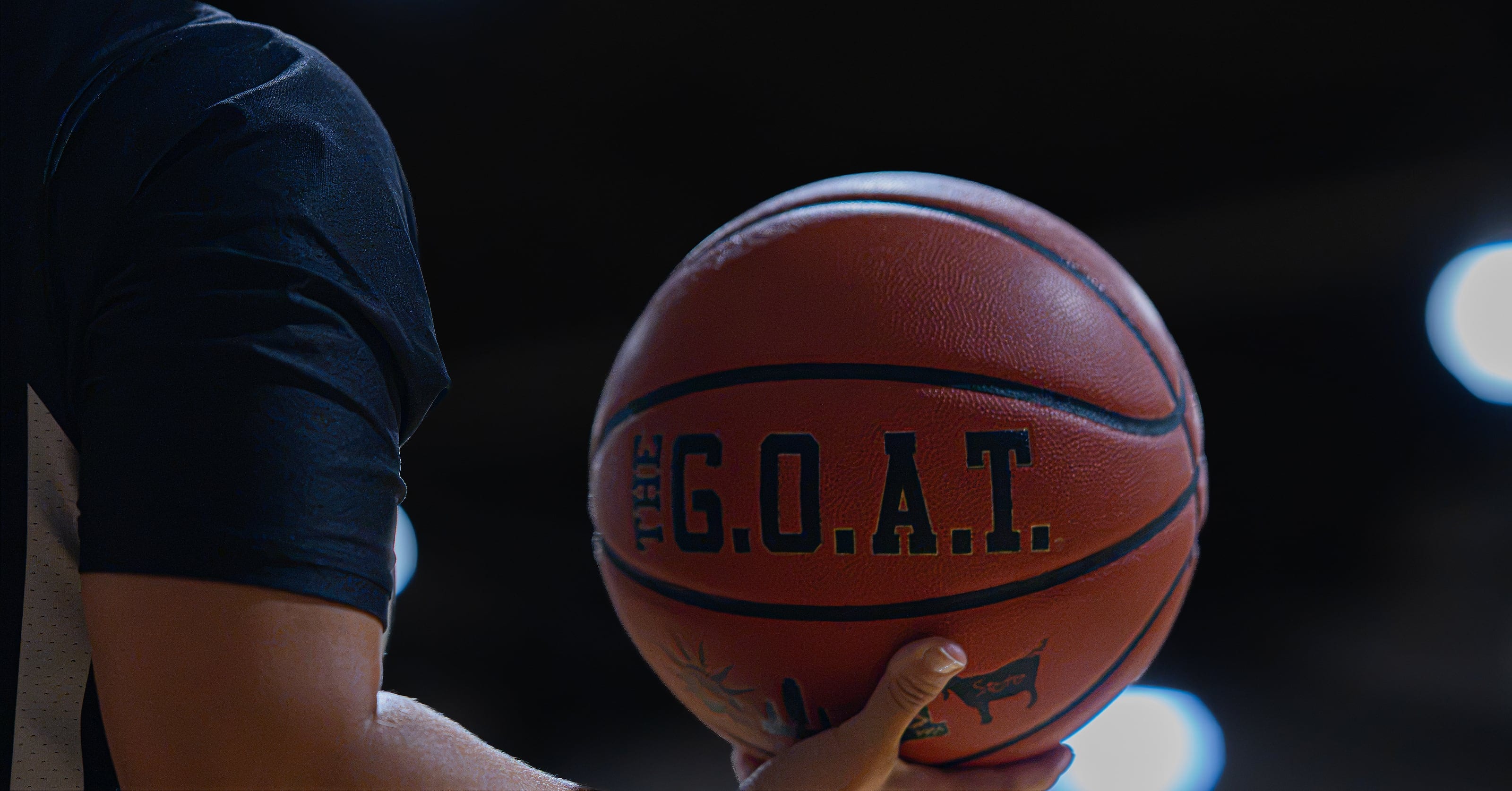 THE G.O.A.T. — the game ball, held courtside