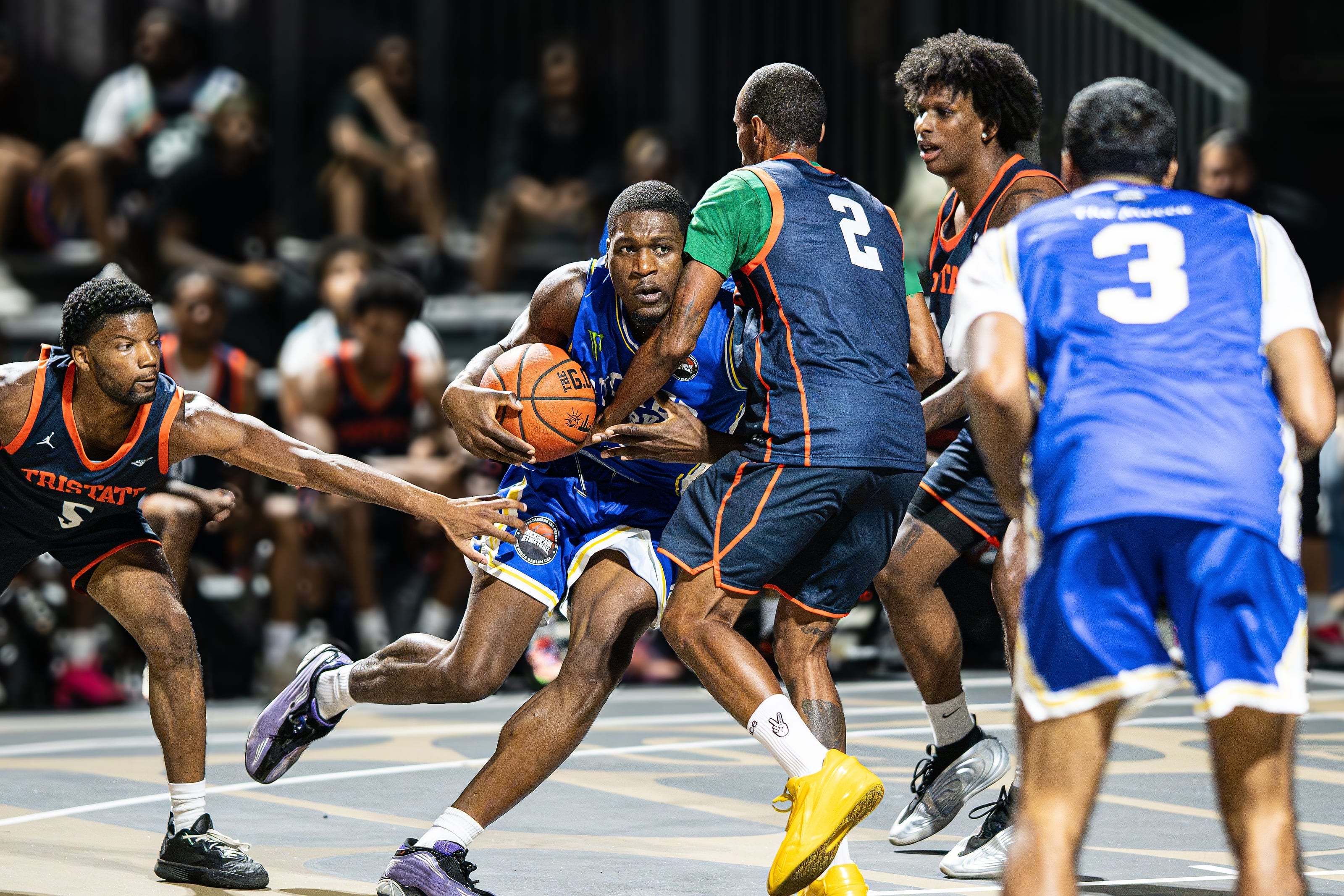 A guard splits three defenders on the drive