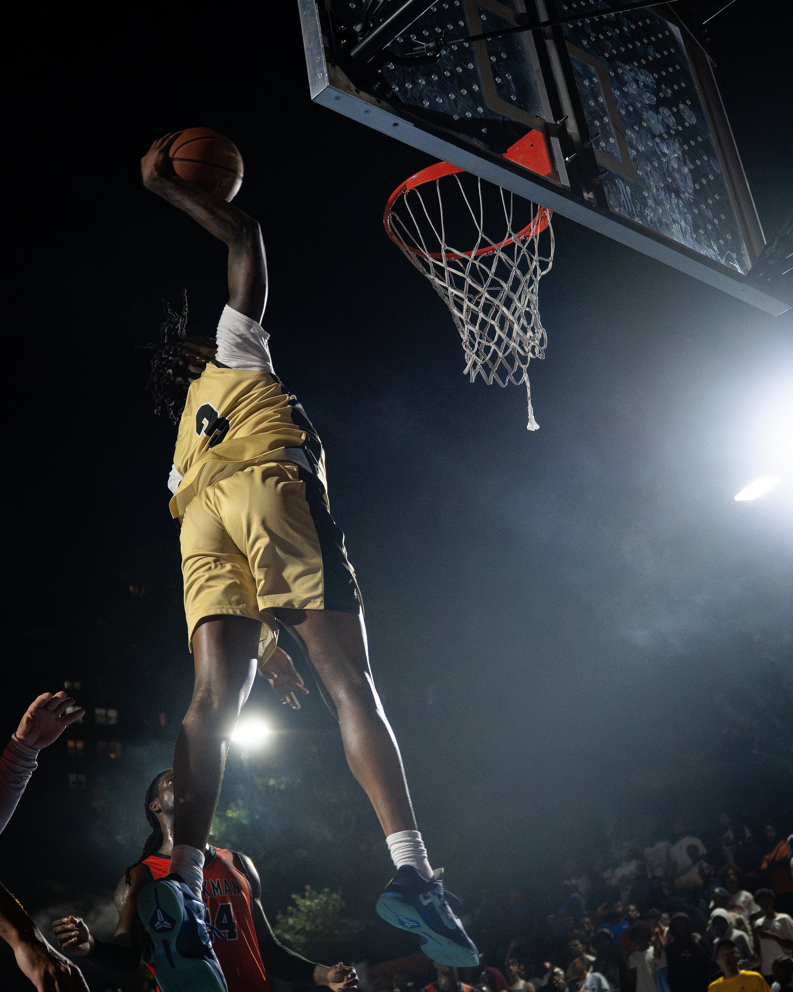 Rising into the spotlight, the ball cocked behind his head