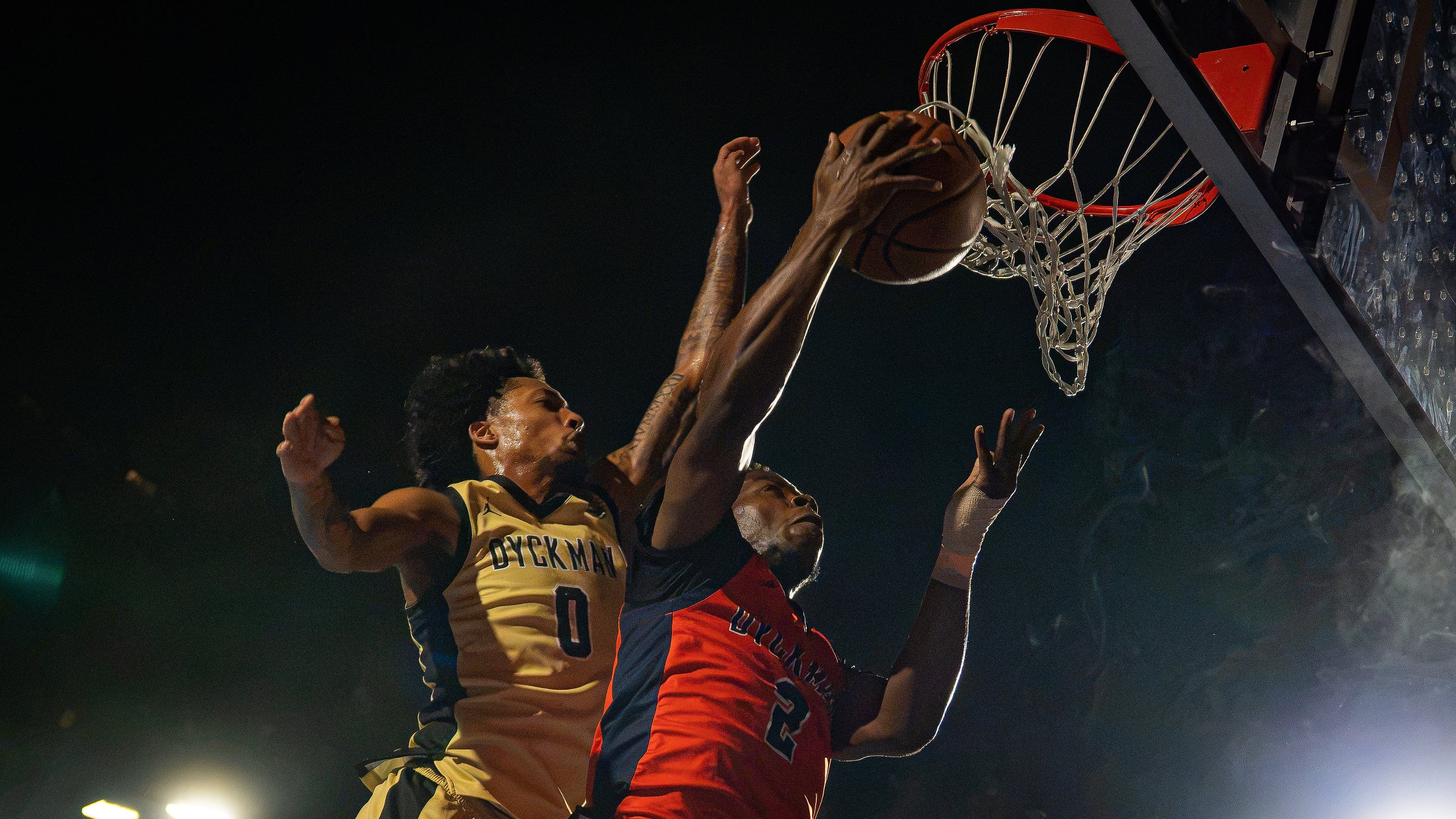Three hands and the ball at the rim, nobody giving way