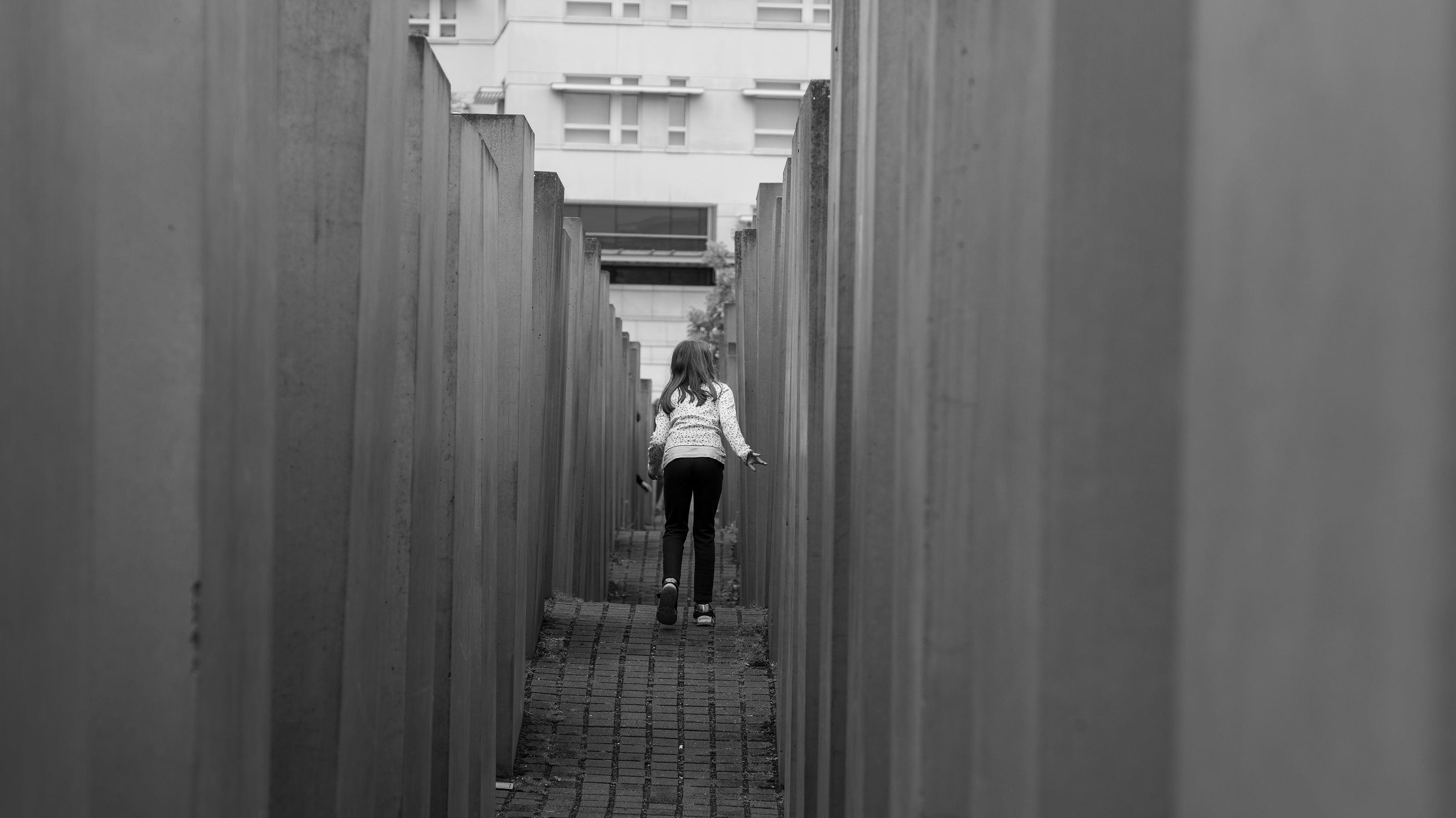 A visitor between the columns of the Holocaust Memorial