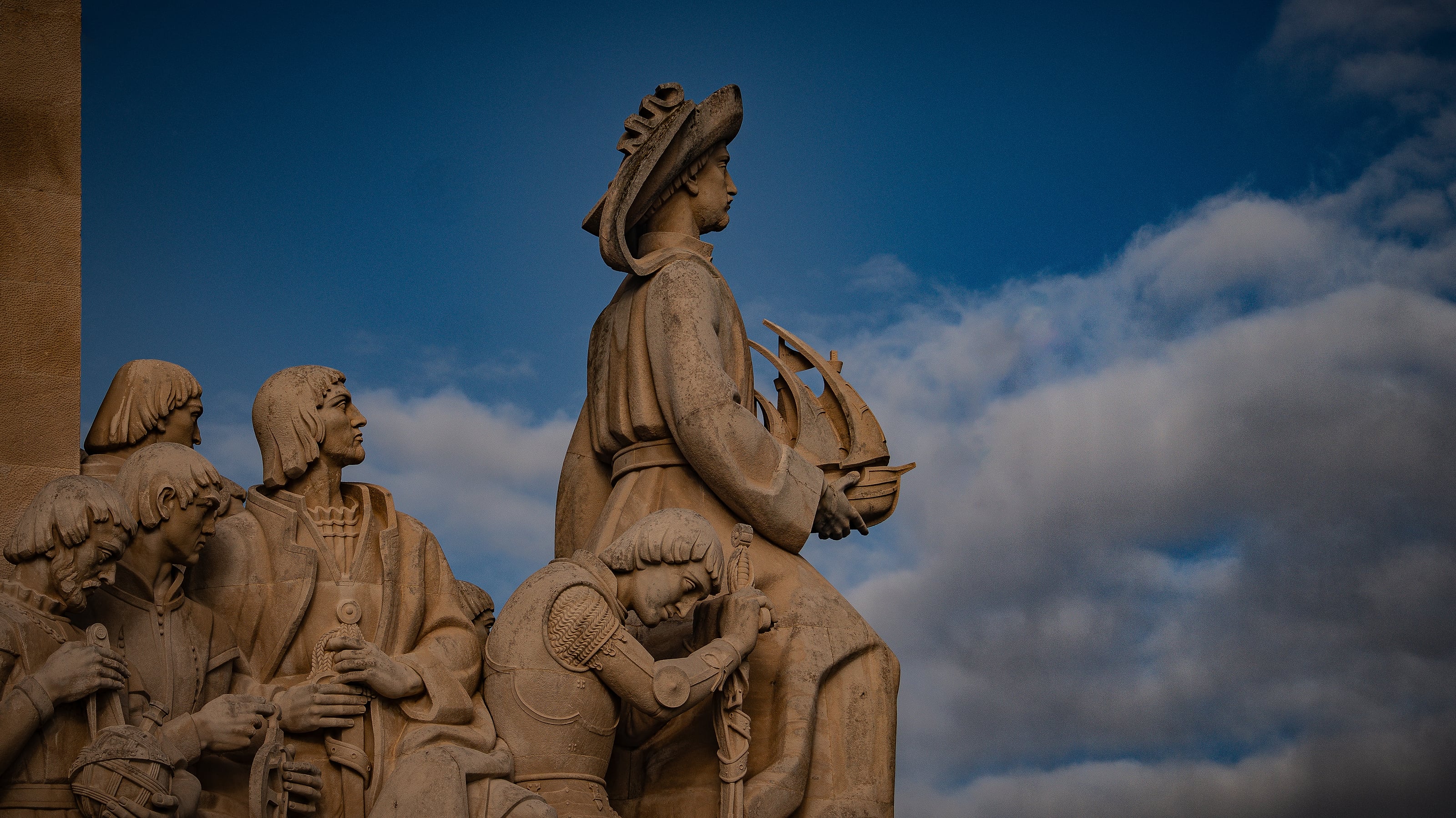 Monumental figures silhouetted against the sky