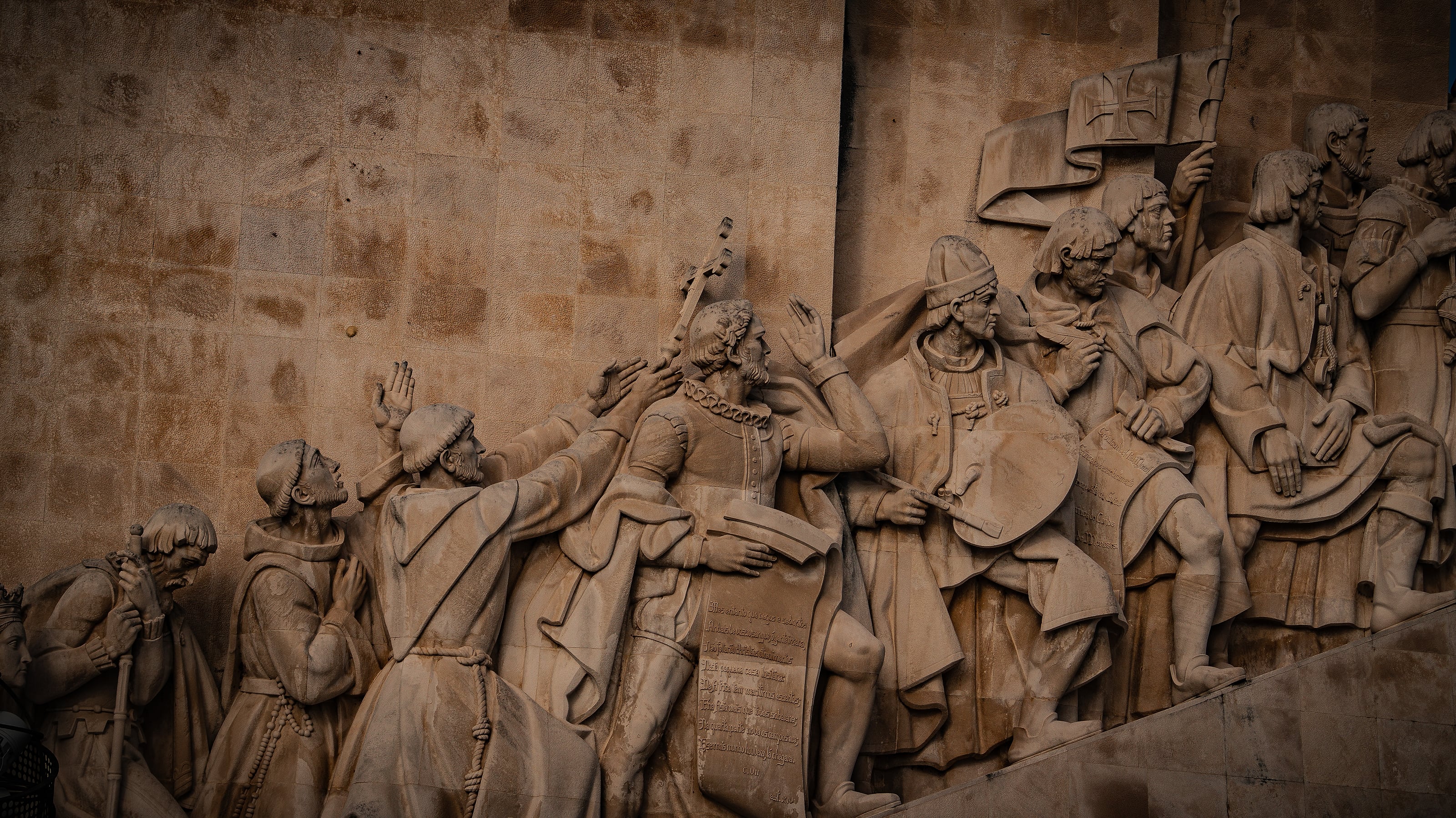 A warmly lit carved stone relief
