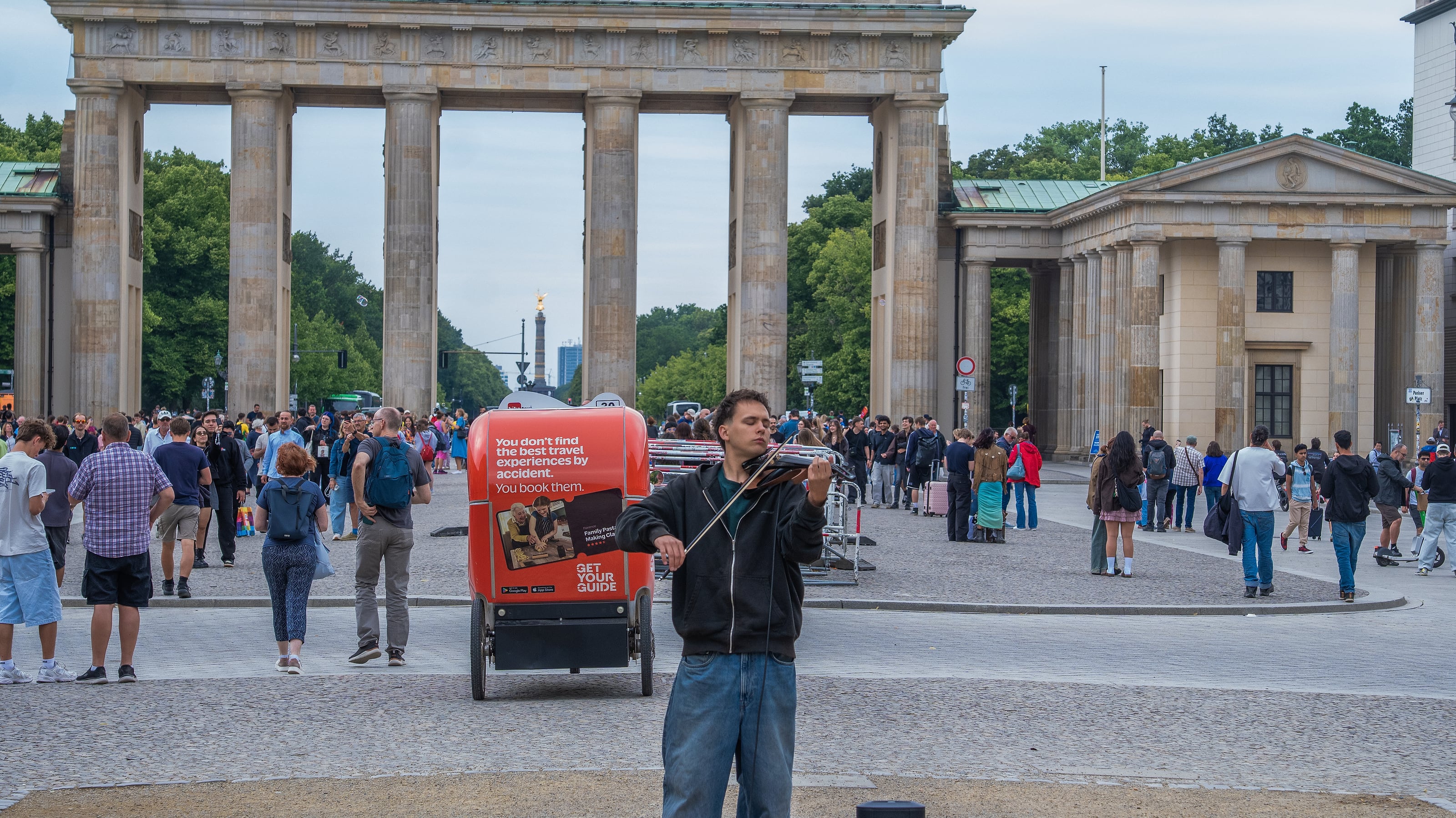 A violinist busking in front of the Brandenburg Gate